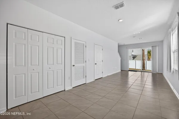 a view of an empty room and a window