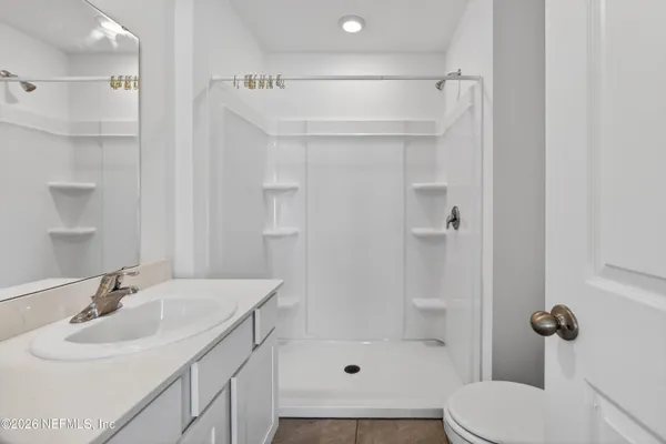 a bedroom with a bed and a potted plant