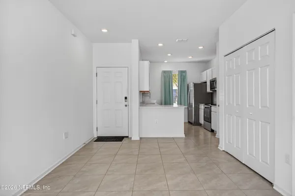 a view of a kitchen with a refrigerator and a sink