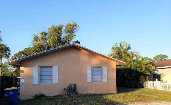 a house that has a tree in front of it