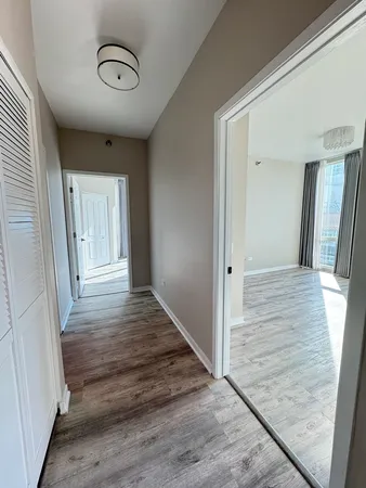 a view of a hallway view with wooden floor and staircase