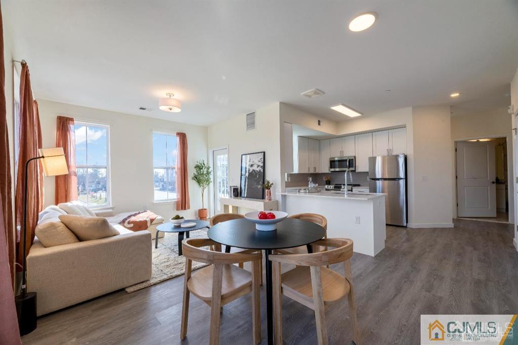 1 Nolan Way, Unit B32F North Brunswick, NJ 08902 - Photo 11 of 82 a living room with kitchen island furniture and a view of kitchen