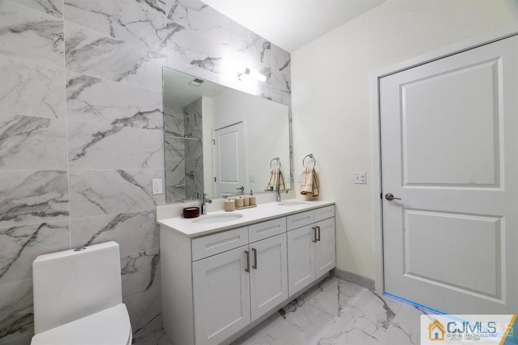 1 Nolan Way, Unit B32F North Brunswick, NJ 08902 - Photo 19 of 82 a bathroom with a sink toilet and mirror