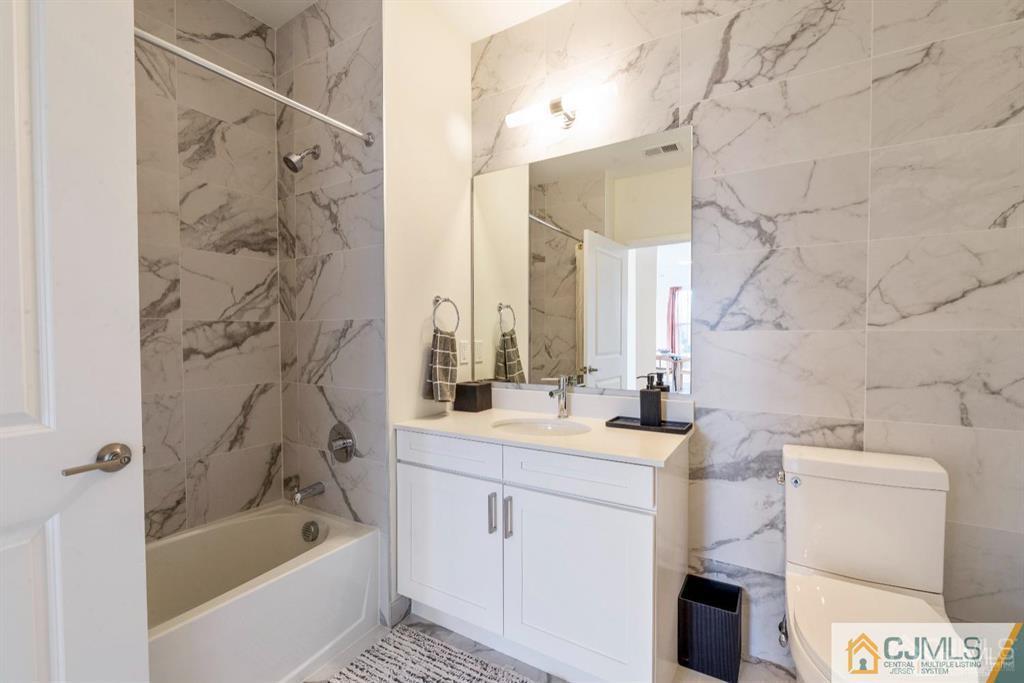 1 Nolan Way, Unit B32F North Brunswick, NJ 08902 - Photo 24 of 82 a bathroom with a sink mirror toilet and bathtub