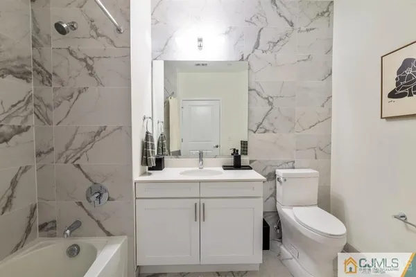 a large kitchen with stainless steel appliances a large counter top