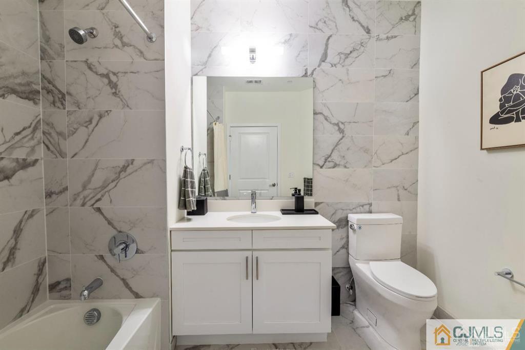 1 Nolan Way, Unit B32F North Brunswick, NJ 08902 - Photo 25 of 82 a bathroom with a sink toilet vanity and bathtub