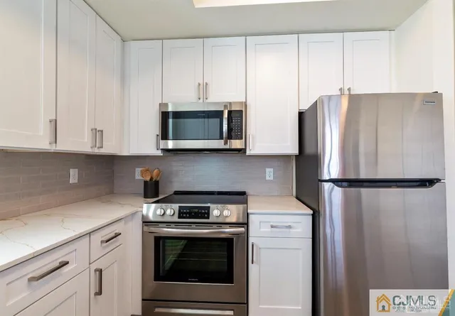 a kitchen with a sink cabinets and window