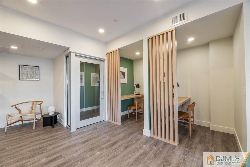 1 Nolan Way, Unit B32F North Brunswick, NJ 08902 - Photo 46 of 82 a view of a hallway with wooden floor and furniture