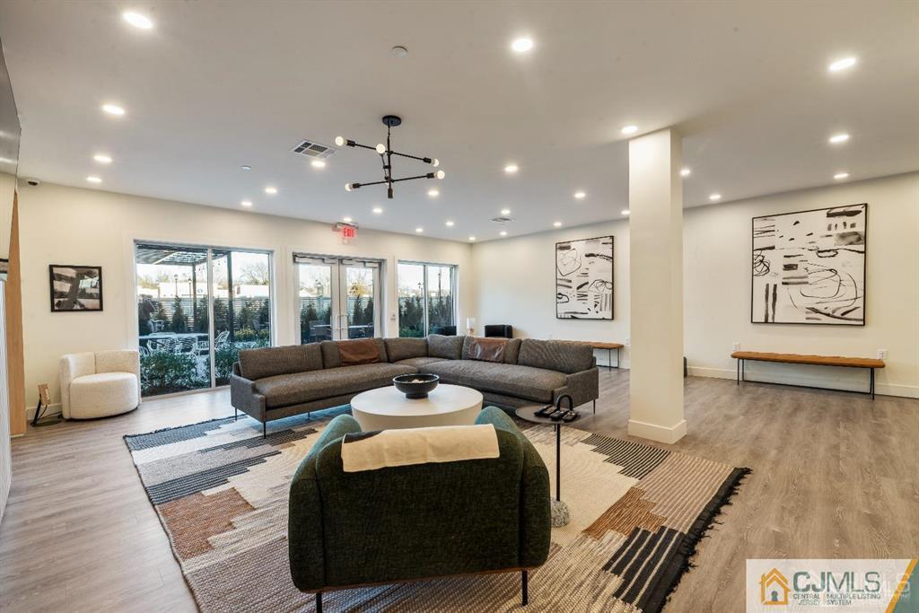 1 Nolan Way, Unit B32F North Brunswick, NJ 08902 - Photo 53 of 82 a living room with furniture and wooden floor
