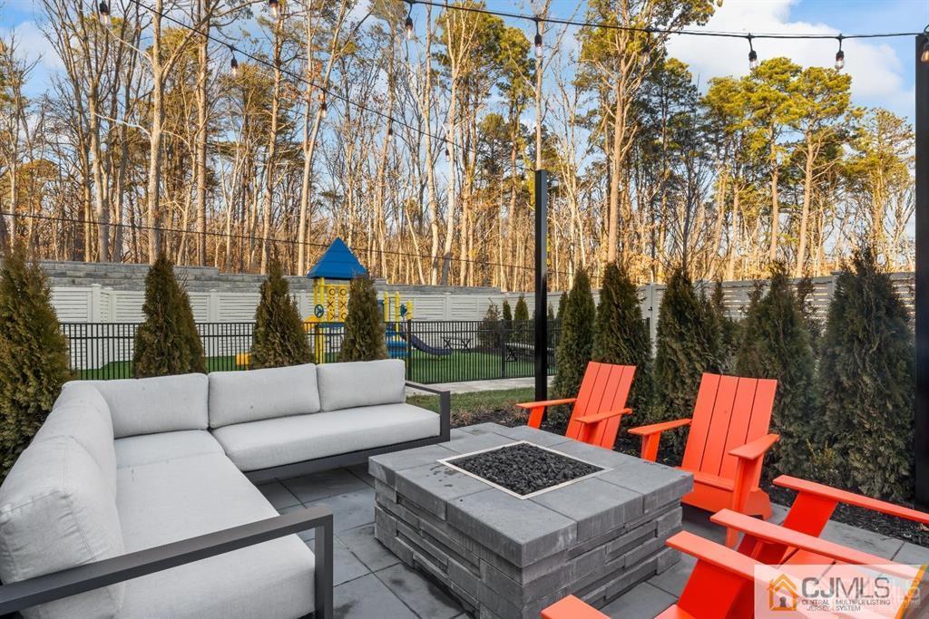 1 Nolan Way, Unit B32F North Brunswick, NJ 08902 - Photo 70 of 82 a outdoor living space with furniture and a fireplace