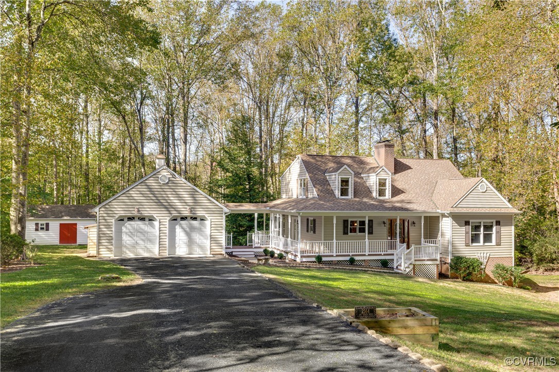 2564 Log Cabin Road Maidens, VA 23102 - Photo 1 of 1 a front view of a house with a yard table and chairs