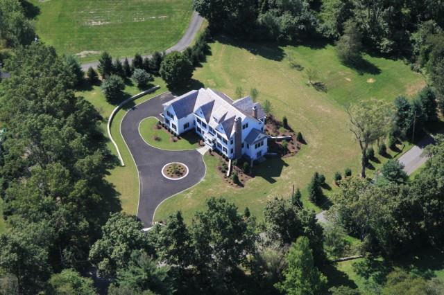 33 Hillbrook Road Wilton, CT 06897 - Photo 1 of 1 an aerial view of a house with outdoor space and a lake view