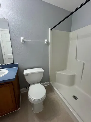 a bathroom with a toilet and a shower