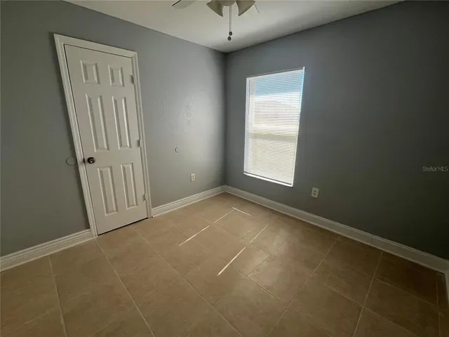 an empty room with windows and entrance