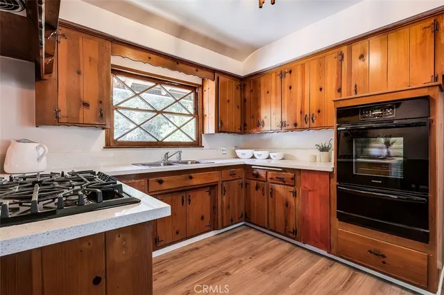 a kitchen with stainless steel appliances a stove a sink and a microwave
