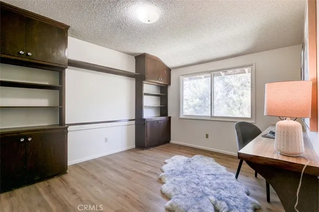 a kitchen with stainless steel appliances a refrigerator sink and wooden floor