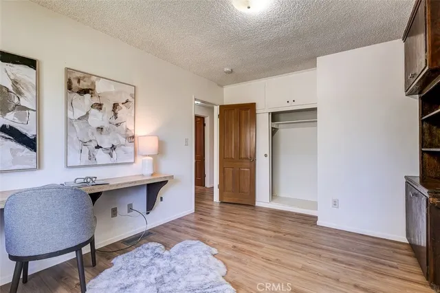 a view of a room with furniture and wooden floor
