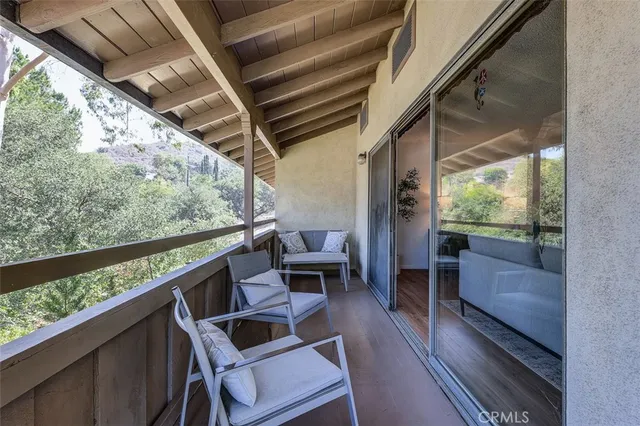a view of balcony with wooden floor
