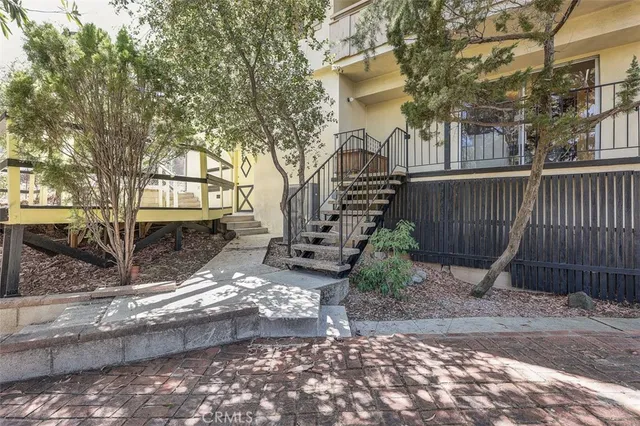 a balcony with wooden floor and fence