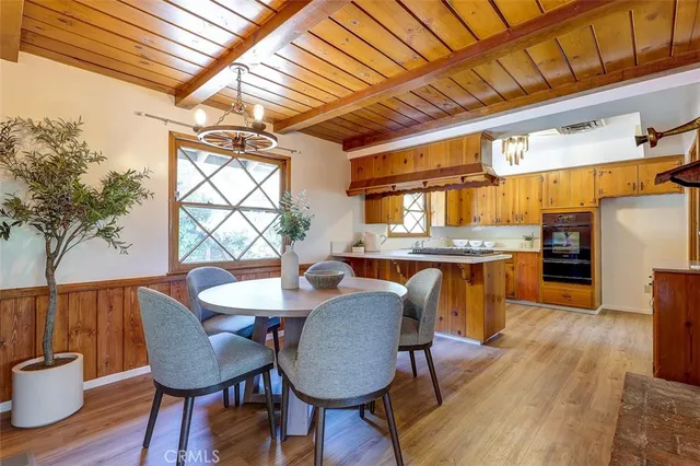 a dining room with furniture and wooden floor