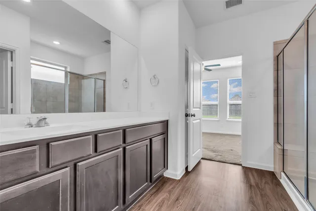 a bathroom with a double vanity sink and mirror