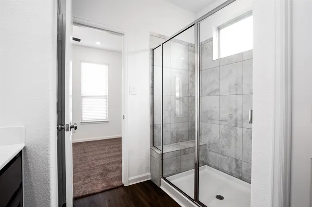 a bathroom with a glass shower door