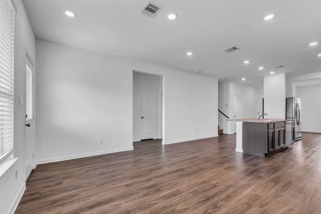 a view of kitchen with wooden floor and windows