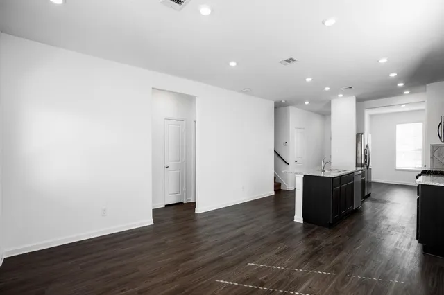 a living room with hard wood flooring and furniture