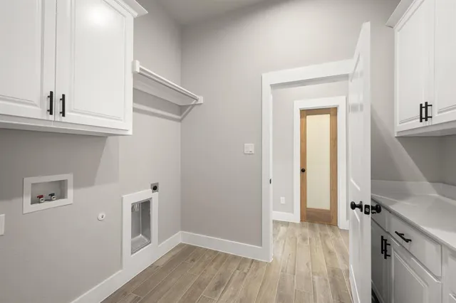 a view of a kitchen cabinets a sink and wooden floor