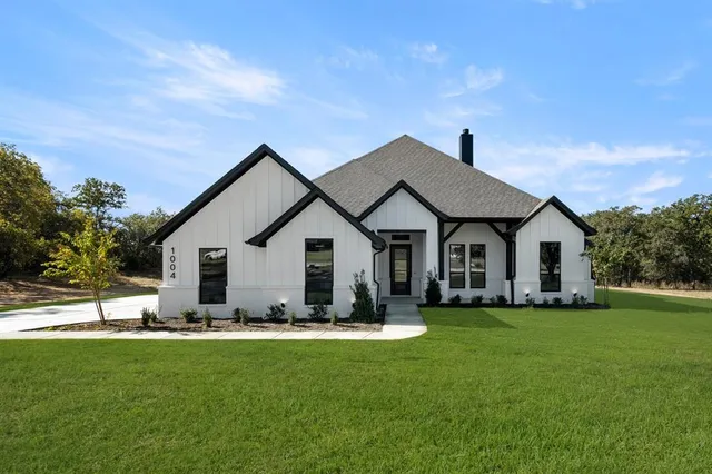 a front view of house with yard and green space
