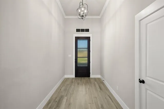 a view of a hallway with wooden floor and a sink