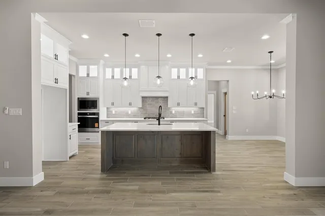 a view of kitchen with kitchen island stainless steel appliances refrigerator stove and microwave
