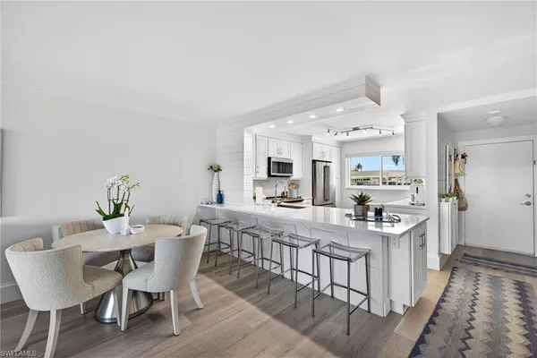a view of a dining room with furniture and wooden floor
