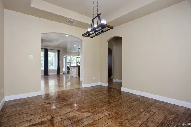 a living room with furniture a large window and a fireplace