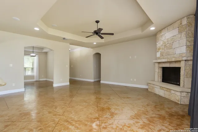 a spacious bedroom with a large bed and a chandelier