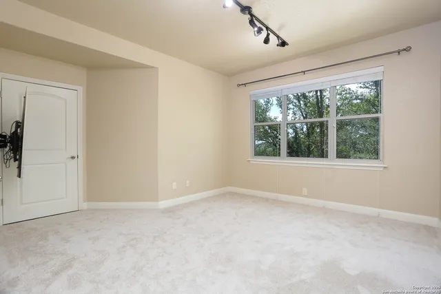 an empty room with windows and closet