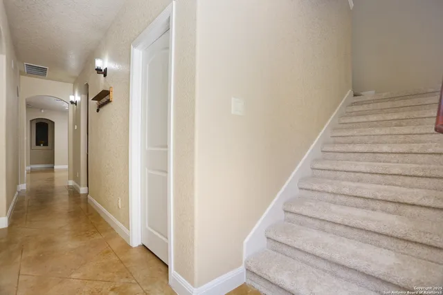 a bathroom with a granite countertop sink a toilet and a mirror