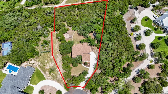 an aerial view of a house with a yard and garden