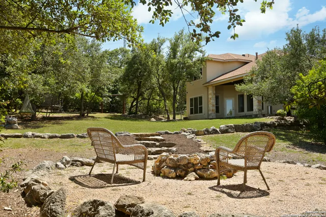 an aerial view of house with yard and mountain view in back