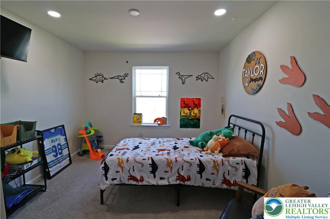 4502 Benjamin Court Emmaus, PA 18049 - Photo 35 of 53 Recessed lighting illuminates this cozy bedroom, creating a tranquil retreat perfect for rest and relaxation.