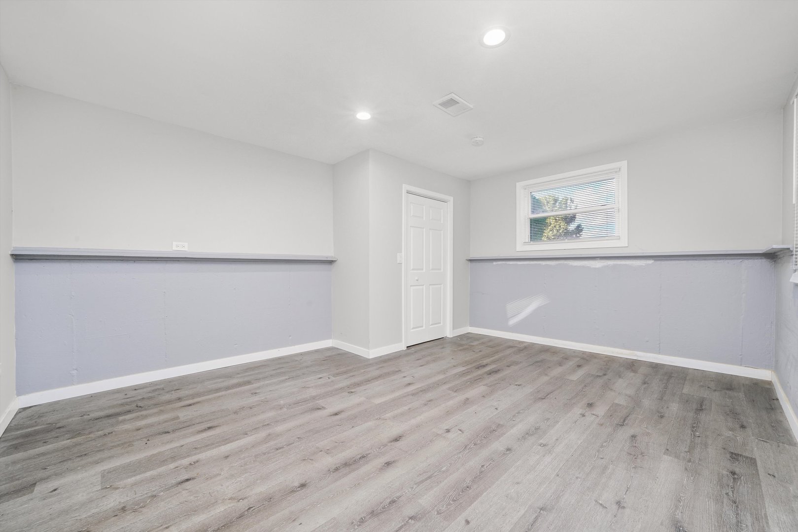 1011 East 142nd Street Dolton, IL 60419 - Photo 13 of 21 an empty room with wooden floor and windows