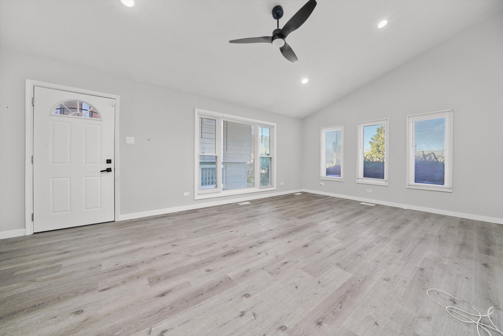1011 East 142nd Street Dolton, IL 60419 - Photo 16 of 21 an empty room with wooden floor cabinet and windows