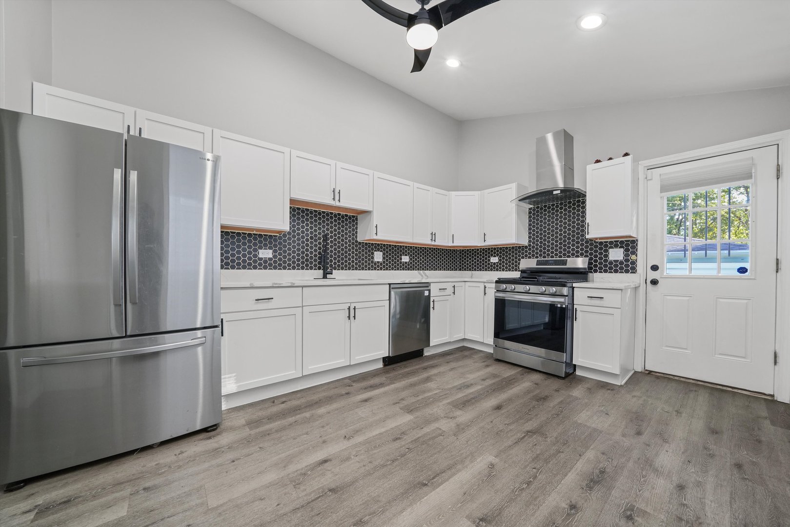 1011 East 142nd Street Dolton, IL 60419 - Photo 9 of 21 a kitchen with white cabinets stainless steel appliances and sink