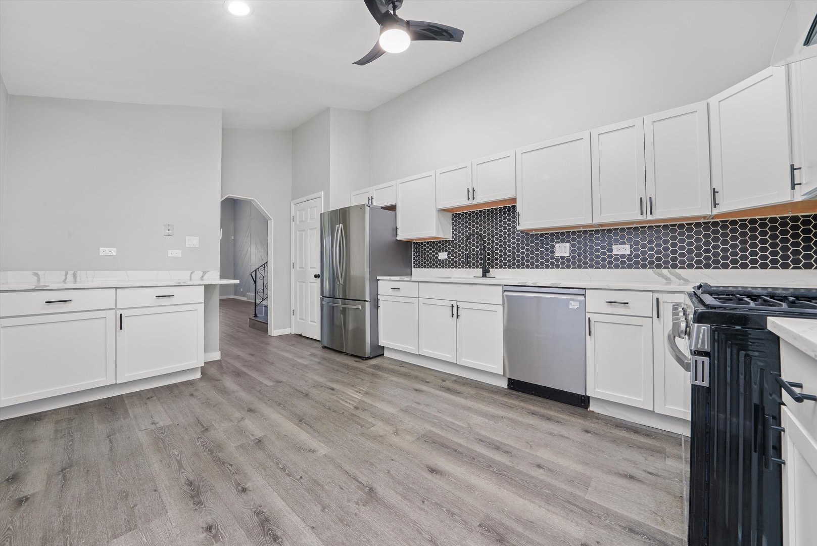 1011 East 142nd Street Dolton, IL 60419 - Photo 10 of 21 a kitchen with stainless steel appliances a sink cabinets and wooden floor