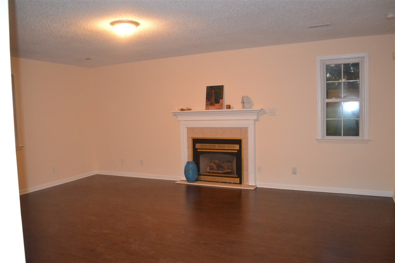 4623 Bragg Road Durham, NC 27704 - Photo 6 of 25 Large Family Room has fireplace, and new laminate floors, fresh paint everywhere Great Room/Family Room