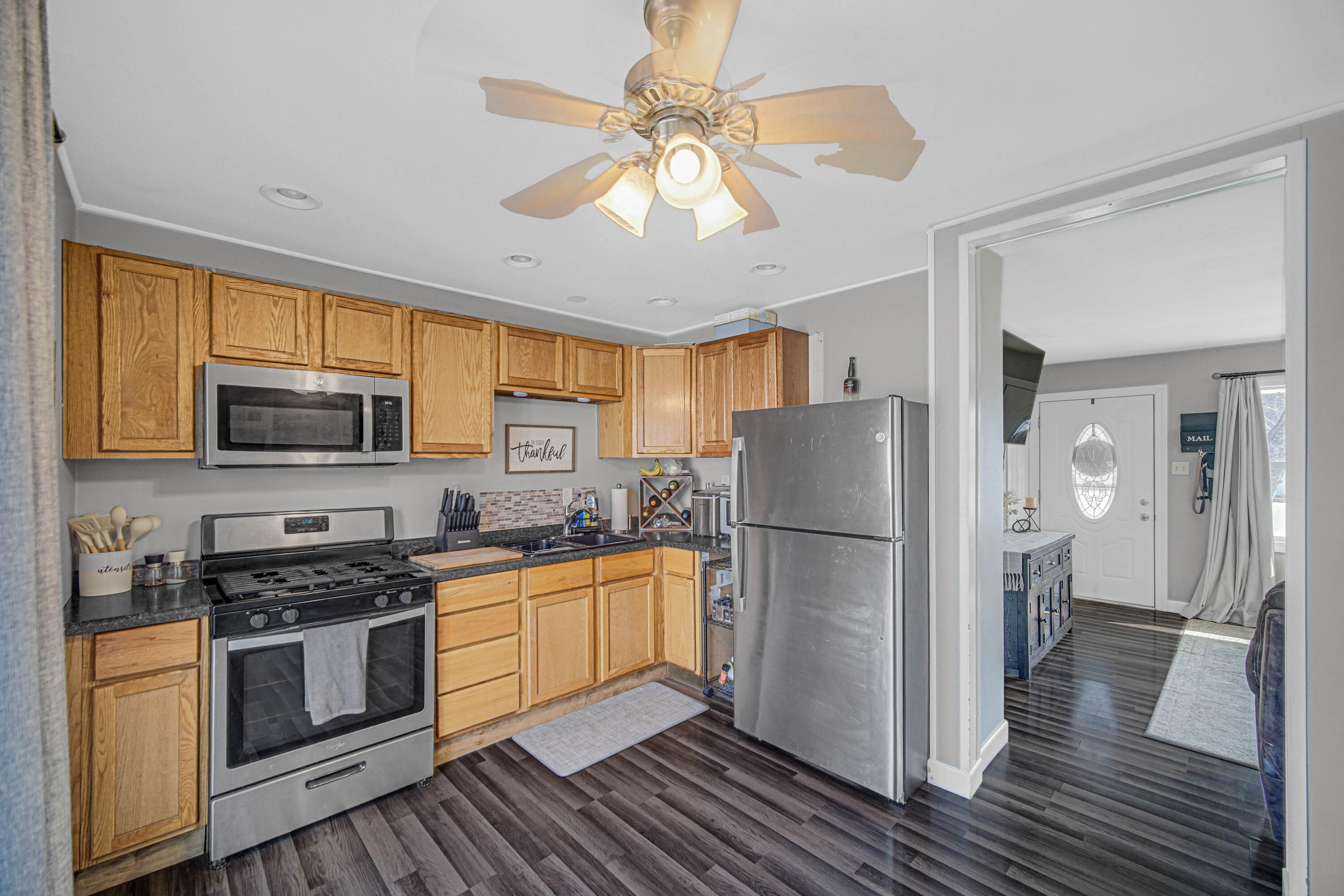 768 Devonshire Road Valparaiso, IN 46385 - Photo 13 of 23 a kitchen with a refrigerator a stove top oven a sink and cabinets