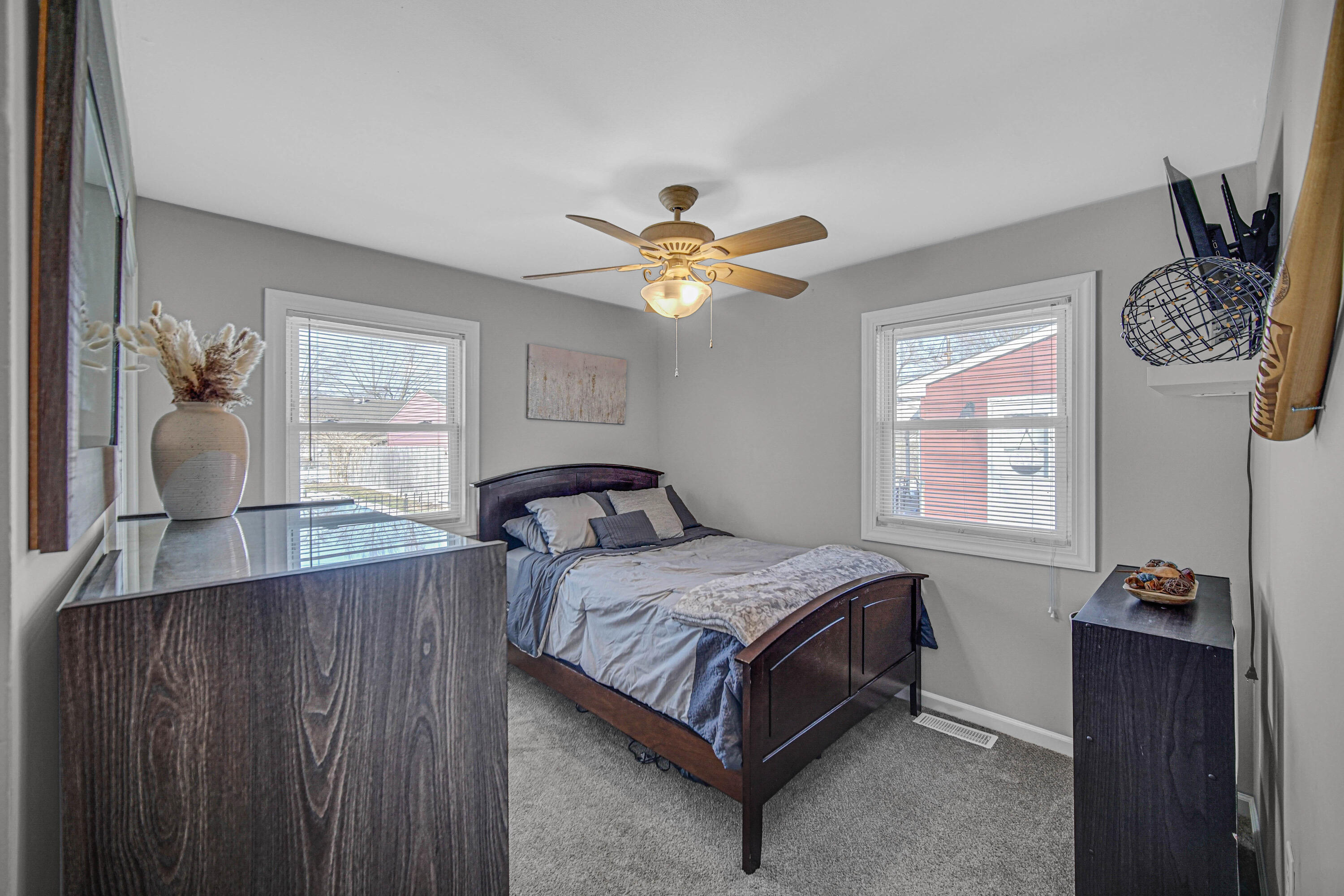 768 Devonshire Road Valparaiso, IN 46385 - Photo 7 of 23 a bedroom with a bed and a chandelier