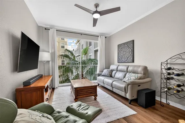 a living room with furniture a flat screen tv and a large window