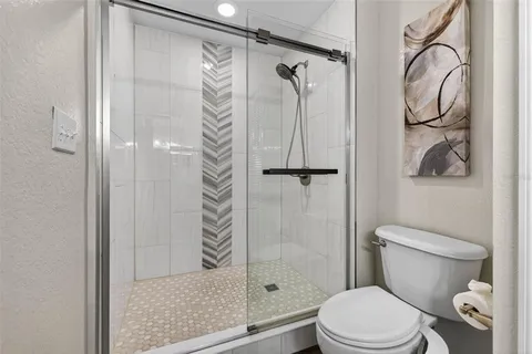 a white toilet sitting next to a bathroom