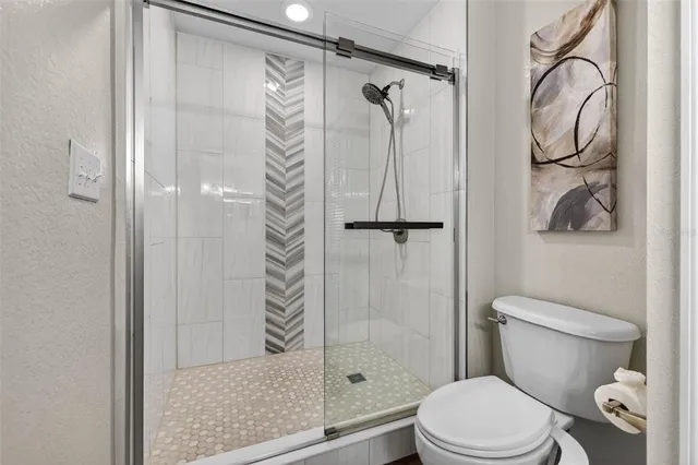 a white toilet sitting next to a bathroom